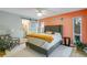 Spacious bedroom with coral accent wall and access to bathroom at 2480 Alamander Ave, Englewood, FL 34223