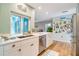 Bright kitchen with white cabinets and a large window at 2480 Alamander Ave, Englewood, FL 34223