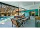Relaxing poolside patio with seating and outdoor dining at 2480 Alamander Ave, Englewood, FL 34223