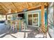 Covered outdoor bar with seating and tropical decor at 2480 Alamander Ave, Englewood, FL 34223