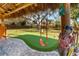 Landscaped backyard with putting green and whimsical decor at 2480 Alamander Ave, Englewood, FL 34223