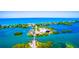 Aerial view of waterfront property with bridge and lush vegetation at 4024 Casey Key Rd, Nokomis, FL 34275