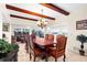 Formal dining room with wood table, leather chairs, and wood beam ceilings at 4024 Casey Key Rd, Nokomis, FL 34275