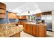 Spacious kitchen with granite countertops, stainless steel appliances, and wood cabinetry at 4024 Casey Key Rd, Nokomis, FL 34275