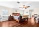 Bright main bedroom with a king-size bed and hardwood floors at 4024 Casey Key Rd, Nokomis, FL 34275