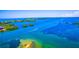Aerial view of a boat cruising on a calm, clear waterway at 4024 Casey Key Rd, Nokomis, FL 34275