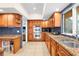 Kitchen with double oven, granite countertops, and wood cabinets at 4024 Casey Key Rd, Nokomis, FL 34275