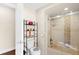 Bathroom with shower/tub combo, toilet, and shelving unit at 4024 Casey Key Rd, Nokomis, FL 34275