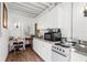 Cozy kitchen with white cabinets, granite counters, and appliances at 4024 Casey Key Rd, Nokomis, FL 34275