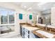 Elegant bathroom with double vanity, granite countertops, and large window at 4024 Casey Key Rd, Nokomis, FL 34275