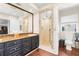 Bathroom with granite countertops, double sinks, and walk-in shower at 4024 Casey Key Rd, Nokomis, FL 34275
