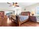 King-size bed, hardwood floors, and water view from main bedroom at 4024 Casey Key Rd, Nokomis, FL 34275