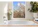 Relaxing bathroom with soaking tub, large window, and modern fixtures at 4024 Casey Key Rd, Nokomis, FL 34275
