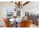 Charming breakfast nook with glass table and wicker chairs, overlooking the backyard at 4024 Casey Key Rd, Nokomis, FL 34275