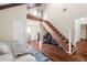 Versatile loft area with hardwood floors, built-in storage, and staircase at 4024 Casey Key Rd, Nokomis, FL 34275