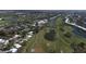 Aerial view of golf course, tennis courts, and community at 731 Carnoustie Ter, Venice, FL 34293