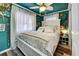 Teal bedroom with white bed and coastal decor at 712 Roma Rd, Venice, FL 34285