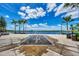 Ground spray fountain near the lake, surrounded by palm trees and pathways at 10780 Tarflower Dr # 101, Venice, FL 34293