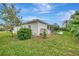 Spacious backyard with lush greenery and a screened patio at 5856 Wilson Rd, Venice, FL 34293