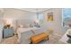 Bright bedroom with a comfy bed, stylish decor, and an ensuite bathroom at 12458 Somatic Ct, Venice, FL 34293