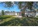 Large backyard with a screened patio, solar panels and lush green grass at 6738 Brentford Rd, Sarasota, FL 34241