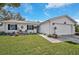White single story home with blue door and spacious yard at 6738 Brentford Rd, Sarasota, FL 34241