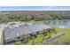 Aerial view of home's back, showcasing screened patio and pond views at 26005 Bimini Sands Ct, Englewood, FL 34223