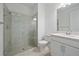 Bathroom features a walk-in shower, toilet, and vanity with sink at 26005 Bimini Sands Ct, Englewood, FL 34223