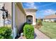 Side view of house showcasing a walkway, lush landscaping, and an inviting entryway at 11560 Okaloosa Dr, Venice, FL 34293