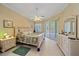 Main bedroom with king-size bed, dresser, and sliding glass doors to the patio at 1622 Landfall Dr, Nokomis, FL 34275