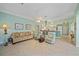 Spacious living room with light teal walls and comfortable seating at 1622 Landfall Dr, Nokomis, FL 34275