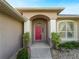 Home features a red door and arched entryway at 2112 S Chamberlain Blvd, North Port, FL 34286