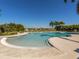 Community pool with a freeform design and lounge chairs at 9823 Haze Dr, Venice, FL 34292