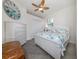 Bedroom with white furniture and ceiling fan at 9823 Haze Dr, Venice, FL 34292