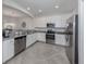 Modern kitchen with stainless steel appliances and granite countertops at 9823 Haze Dr, Venice, FL 34292