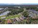 Aerial view of homes and a lake in a community at 11712 Hendry Loop, Venice, FL 34293