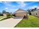 Tan one-story house with landscaped yard at 229 Fareham Dr, Venice, FL 34293