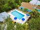 Community pool with umbrellas and lounge chairs at 229 Fareham Dr, Venice, FL 34293