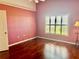 Hardwood floor bedroom with window and pink walls at 745 Harrington Lake N Dr # 30, Venice, FL 34293