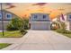 Two-story house with gray exterior, red door, and two-car garage at 11898 Tempest Harbor Loop, Venice, FL 34292