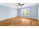 Bright bedroom with wood-look flooring and ceiling fan at 11898 Tempest Harbor Loop, Venice, FL 34292