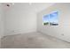 Unfinished bedroom with large window and concrete flooring at 1247 Graham Rd, Venice, FL 34293