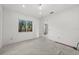 Spacious bedroom with large window and concrete floor at 1247 Graham Rd, Venice, FL 34293