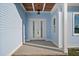 Front entrance featuring double white doors and light blue siding at 1247 Graham Rd, Venice, FL 34293