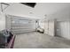 Large garage with ample storage shelving and an overhead door at 1247 Graham Rd, Venice, FL 34293