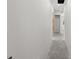 Long hallway with concrete floors and painted walls at 1247 Graham Rd, Venice, FL 34293