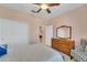 Guest bedroom with wood dresser and window with plantation shutters at 13339 Pacchio St, Venice, FL 34293