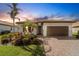 One-story home with a brown garage door and well-manicured landscaping at 13339 Pacchio St, Venice, FL 34293