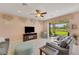 Bright living room with fireplace and sliding glass doors to backyard at 13339 Pacchio St, Venice, FL 34293