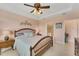 Main bedroom with king bed, ensuite bathroom access, and ceiling fan at 13339 Pacchio St, Venice, FL 34293